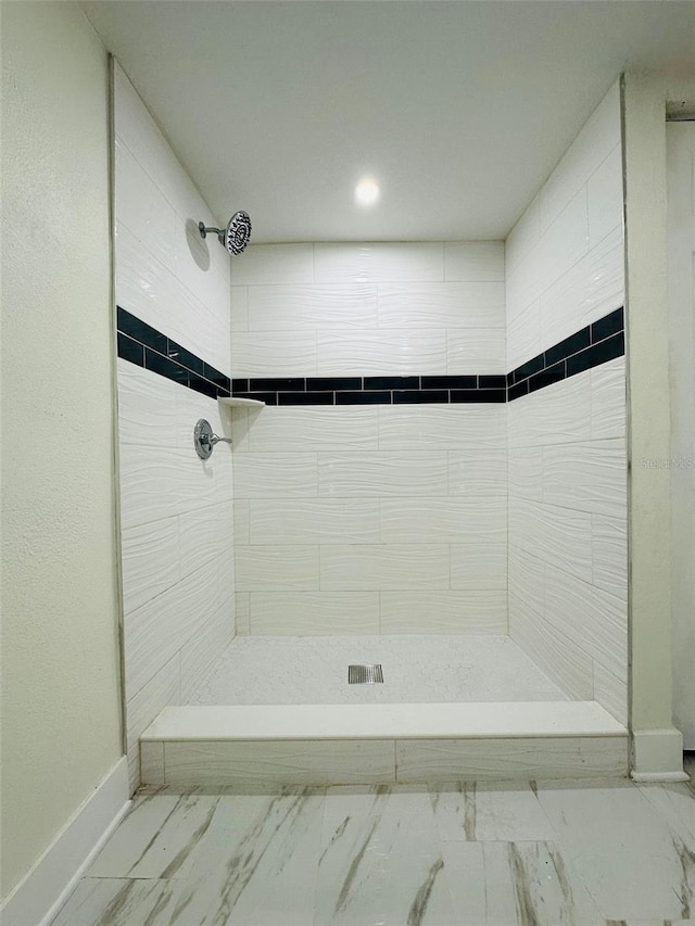 bathroom with tiled shower