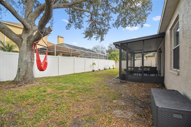 view of yard with central AC unit and a sunroom