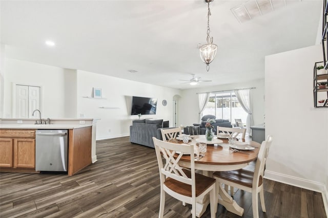 dining area with dark wood-type flooring, ceiling fan, and sink