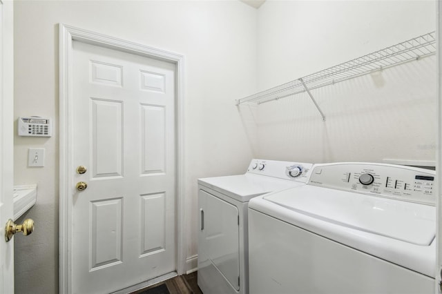 laundry area featuring washer and clothes dryer and dark hardwood / wood-style floors