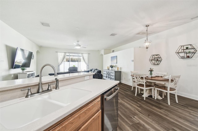 kitchen featuring sink, hanging light fixtures, stainless steel dishwasher, dark hardwood / wood-style floors, and ceiling fan