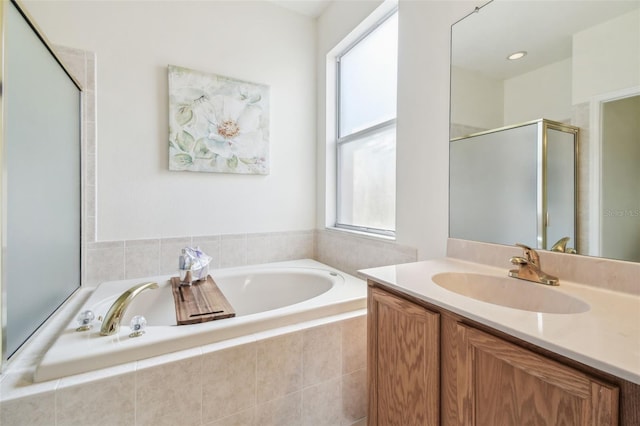 bathroom featuring vanity and shower with separate bathtub