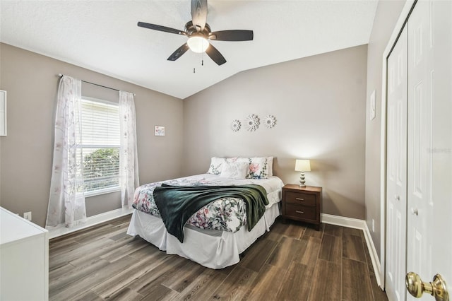 bedroom featuring ceiling fan, lofted ceiling, dark hardwood / wood-style flooring, and a closet