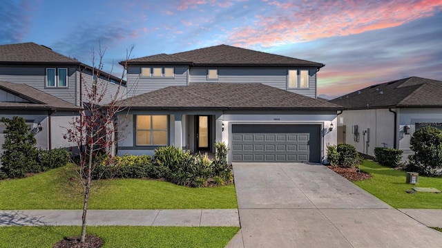 view of front property featuring a garage and a yard