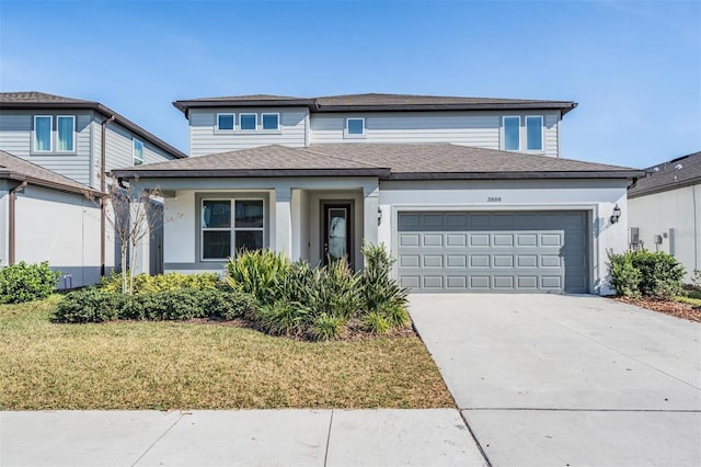 view of front of property featuring a garage and a front lawn