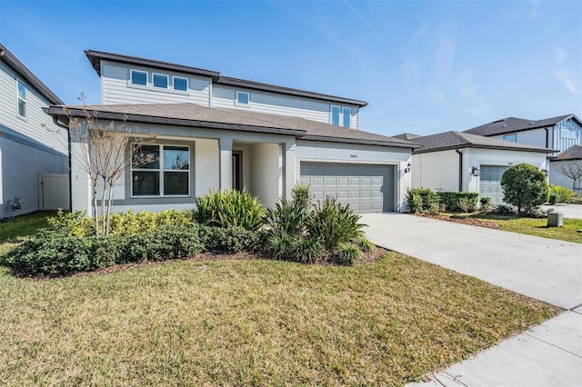 view of front of home with a garage and a front lawn