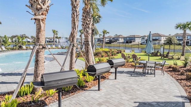 view of property's community with a pool and a patio area