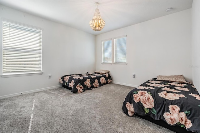 bedroom with light colored carpet and a chandelier