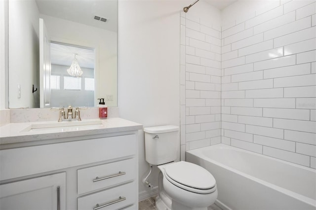 full bathroom with vanity, tiled shower / bath, toilet, and an inviting chandelier