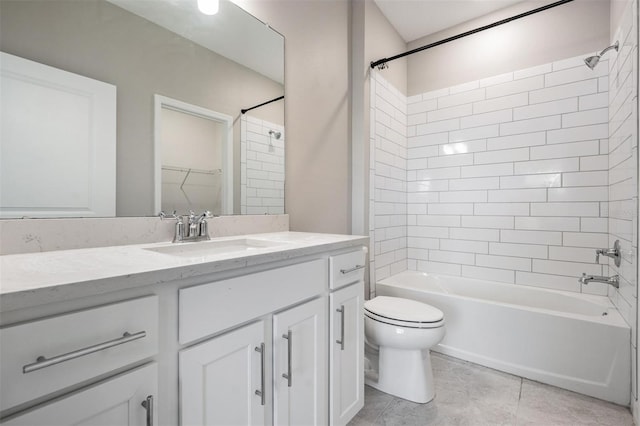 full bathroom with tiled shower / bath, vanity, toilet, and tile patterned floors