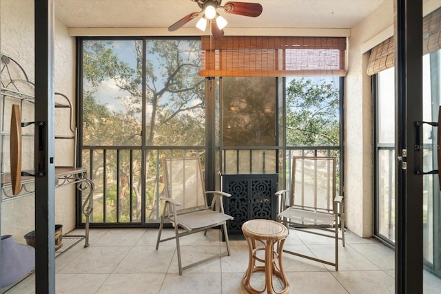 sunroom / solarium featuring ceiling fan