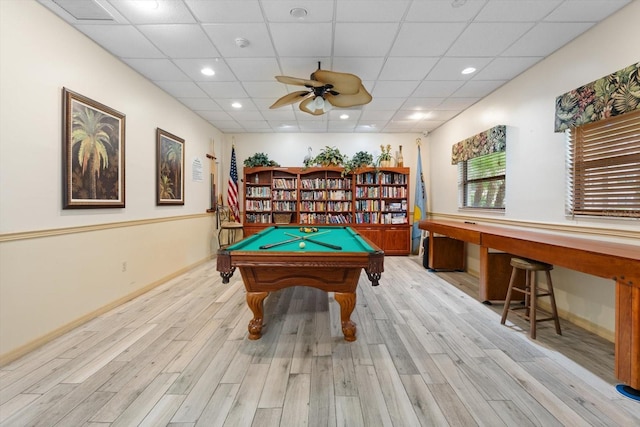 playroom with built in desk, light hardwood / wood-style floors, ceiling fan, and a paneled ceiling