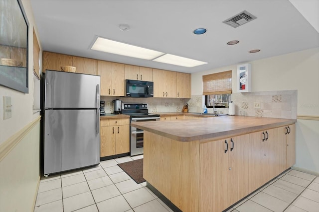 kitchen with appliances with stainless steel finishes, sink, light brown cabinetry, and kitchen peninsula