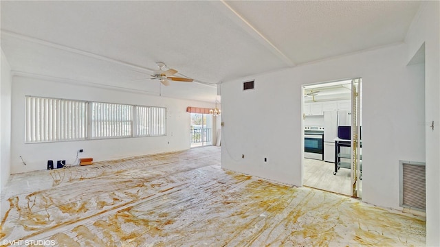 spare room with ceiling fan with notable chandelier and a textured ceiling