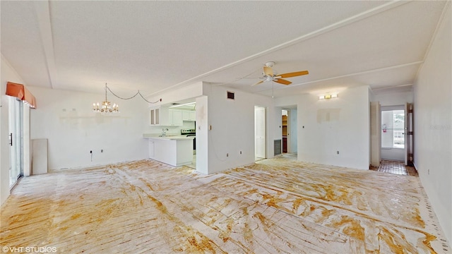 unfurnished living room with ceiling fan with notable chandelier