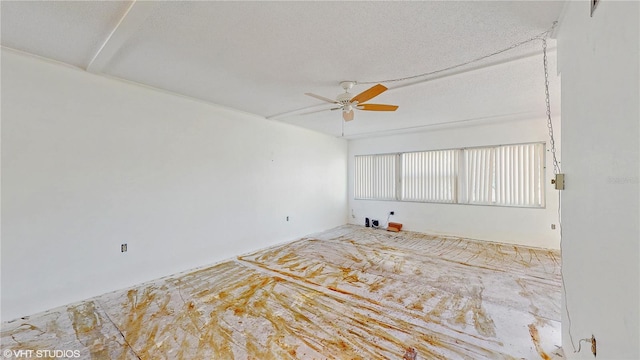 spare room featuring ceiling fan and a textured ceiling