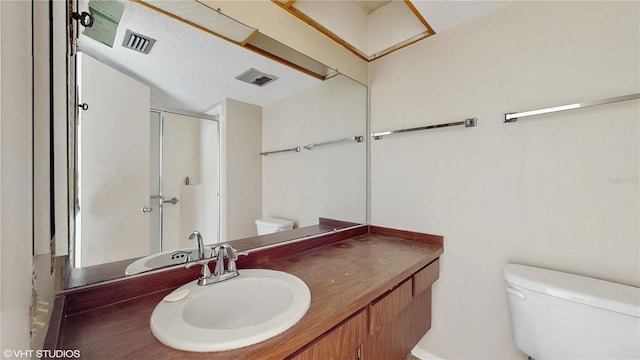 bathroom with vanity, toilet, and walk in shower