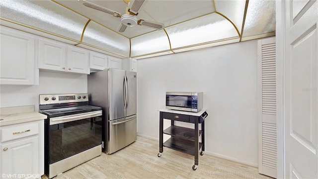 kitchen featuring ceiling fan, light wood-type flooring, white cabinets, and appliances with stainless steel finishes