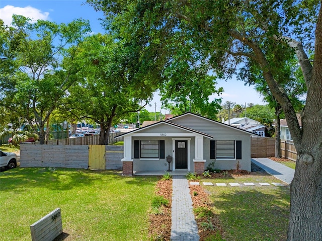 view of front of house with covered porch and a front lawn