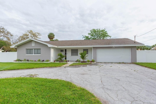 ranch-style home with a garage and a front yard