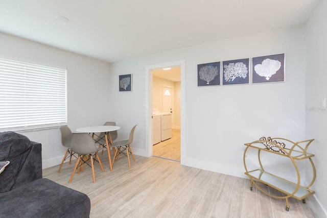 dining space featuring independent washer and dryer and light hardwood / wood-style floors