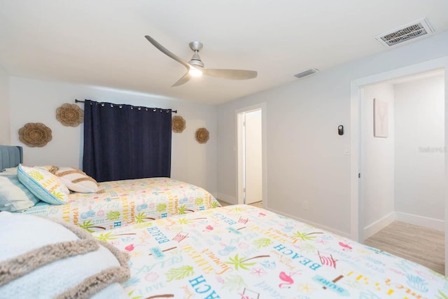 bedroom with ceiling fan and light hardwood / wood-style flooring