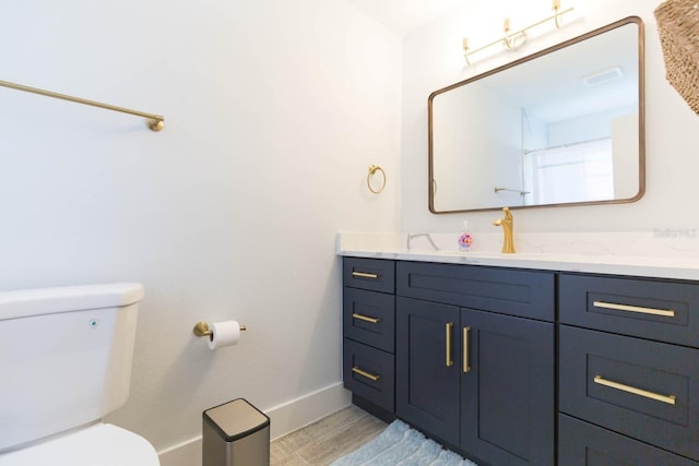 bathroom featuring vanity and toilet