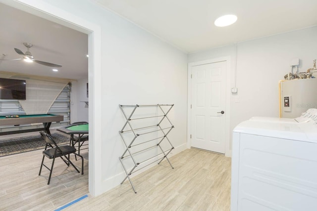 washroom with washer and dryer, light hardwood / wood-style flooring, water heater, and ceiling fan