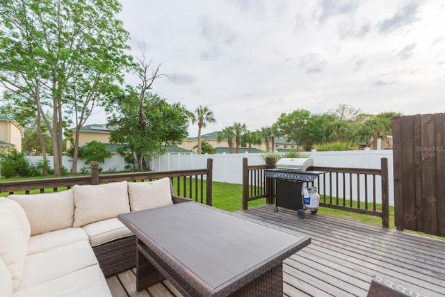 wooden terrace featuring area for grilling and an outdoor hangout area