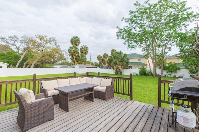 deck with grilling area, an outdoor hangout area, and a lawn