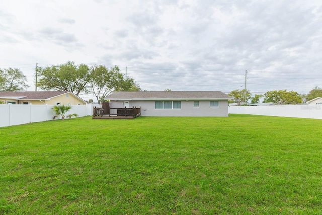 back of house featuring a yard and a deck