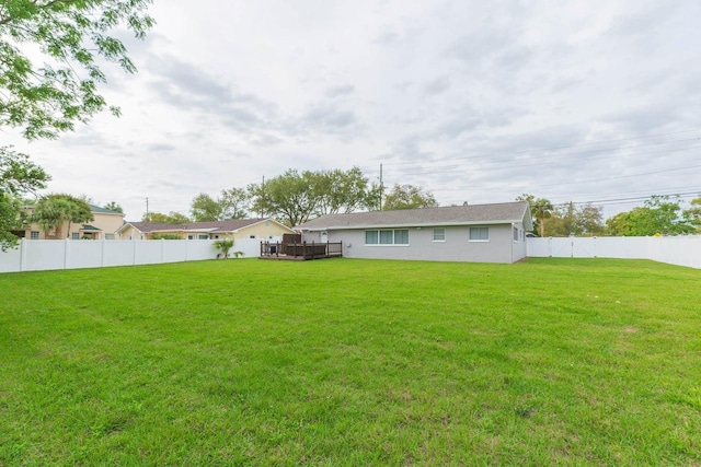 rear view of house featuring a yard