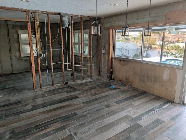 miscellaneous room featuring hardwood / wood-style floors and a textured ceiling