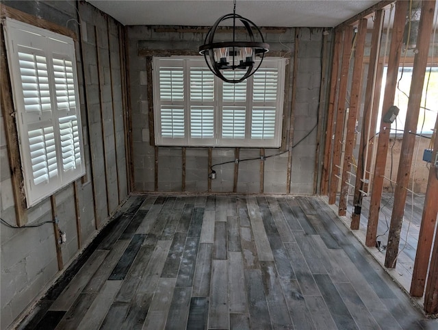 unfurnished dining area with dark wood-type flooring