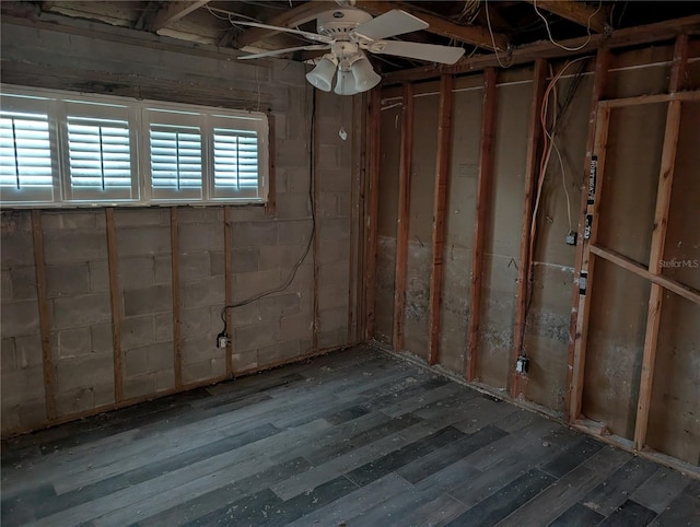 basement featuring ceiling fan and dark hardwood / wood-style flooring