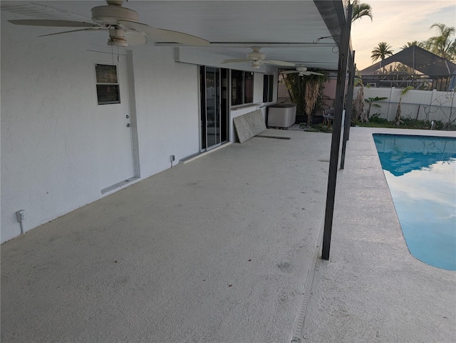 pool at dusk featuring a patio area