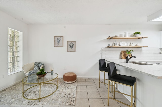 interior space featuring light tile patterned flooring and sink