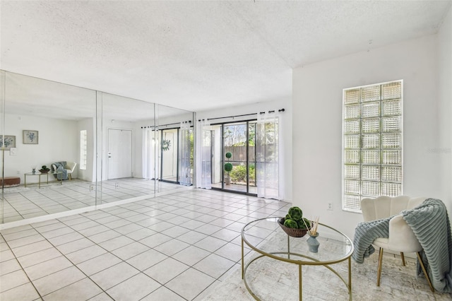 tiled living room featuring a textured ceiling