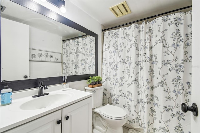 bathroom with vanity, toilet, and walk in shower