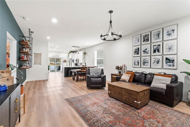 living room featuring light hardwood / wood-style flooring and a chandelier