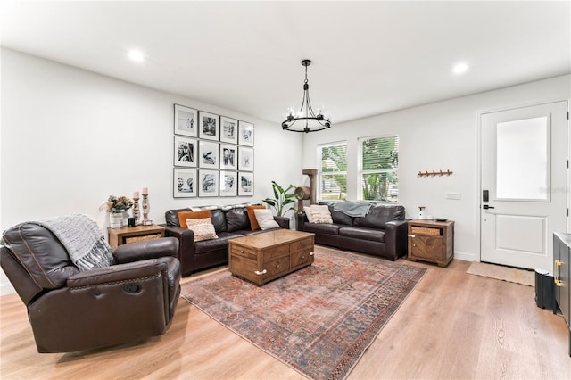 living room with an inviting chandelier and light hardwood / wood-style floors