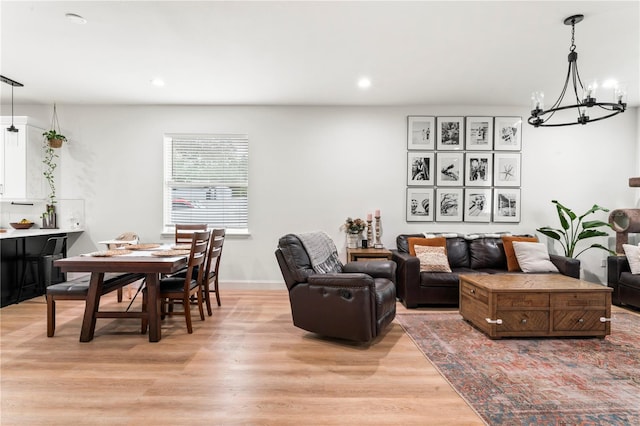 living room featuring light hardwood / wood-style floors and a notable chandelier