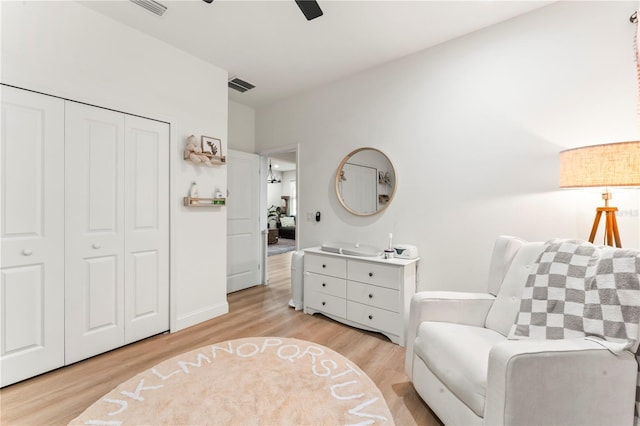 living area featuring ceiling fan and light hardwood / wood-style floors