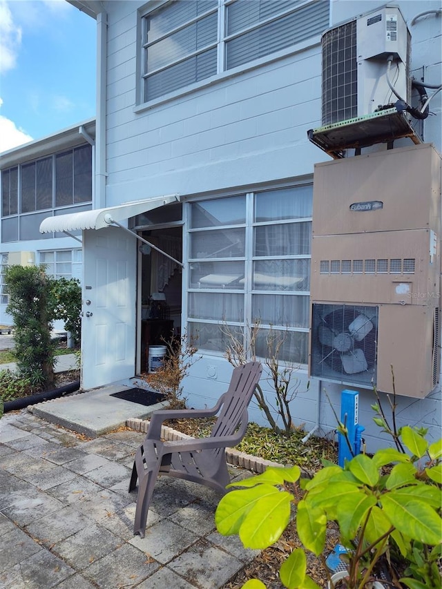 entrance to property featuring central air condition unit