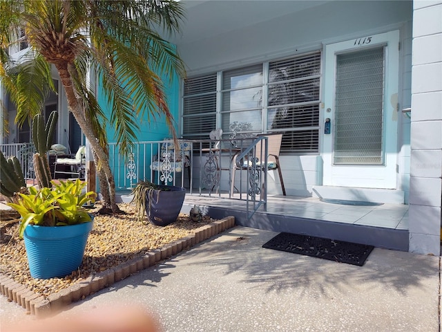 view of exterior entry with a porch