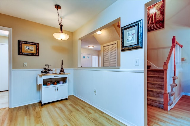 interior space featuring decorative light fixtures and light hardwood / wood-style flooring