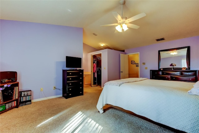 carpeted bedroom featuring ceiling fan, lofted ceiling, a spacious closet, and a closet