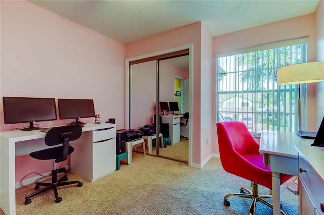 carpeted home office with a textured ceiling