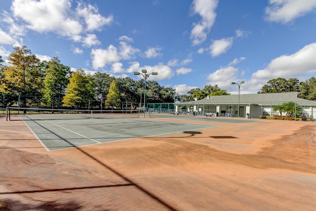 view of tennis court featuring fence