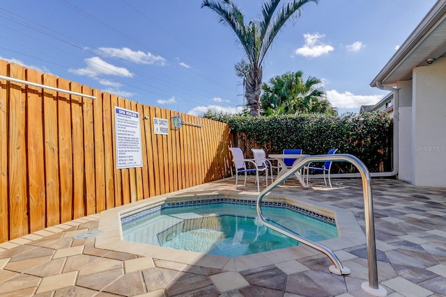 view of swimming pool with a hot tub and a patio